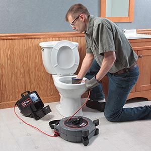 Jerry is using a Ridgid video camera to inspect a toile drain